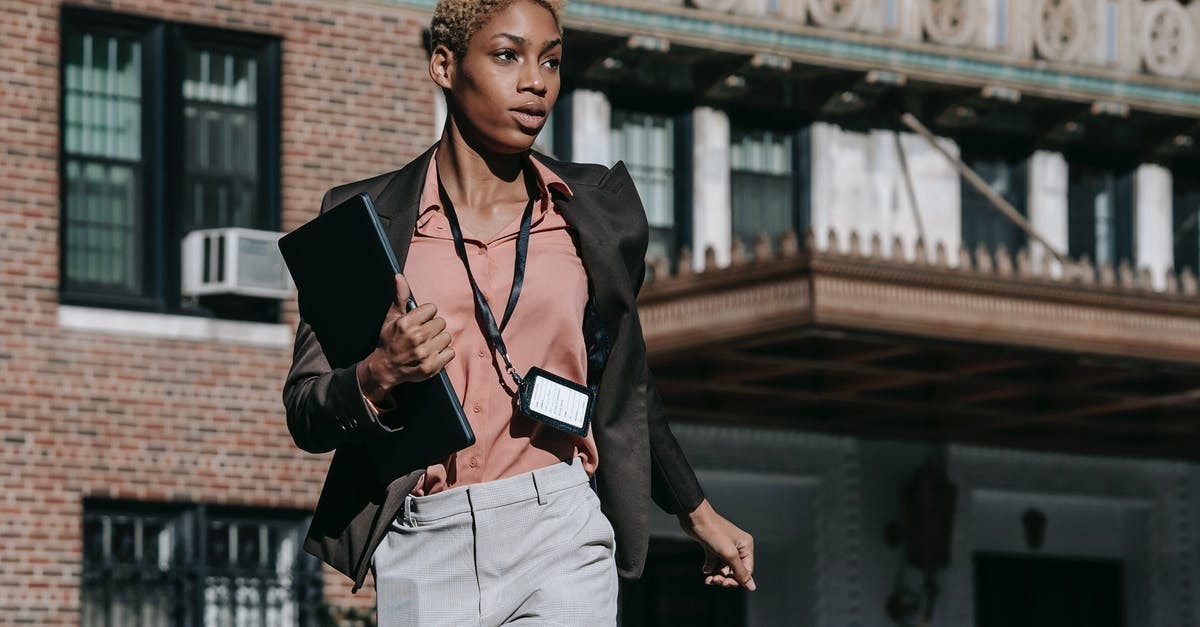 FIFA 16 Sprinting + Teammate Run issue in PC - Confident African American female entrepreneur in classy outfit with badge carrying laptop while running fast on street FIFA 16 Sprinting + Teammate Run issue in PC - Confident African American female entrepreneur in classy outfit with badge carrying laptop while running fast on street
