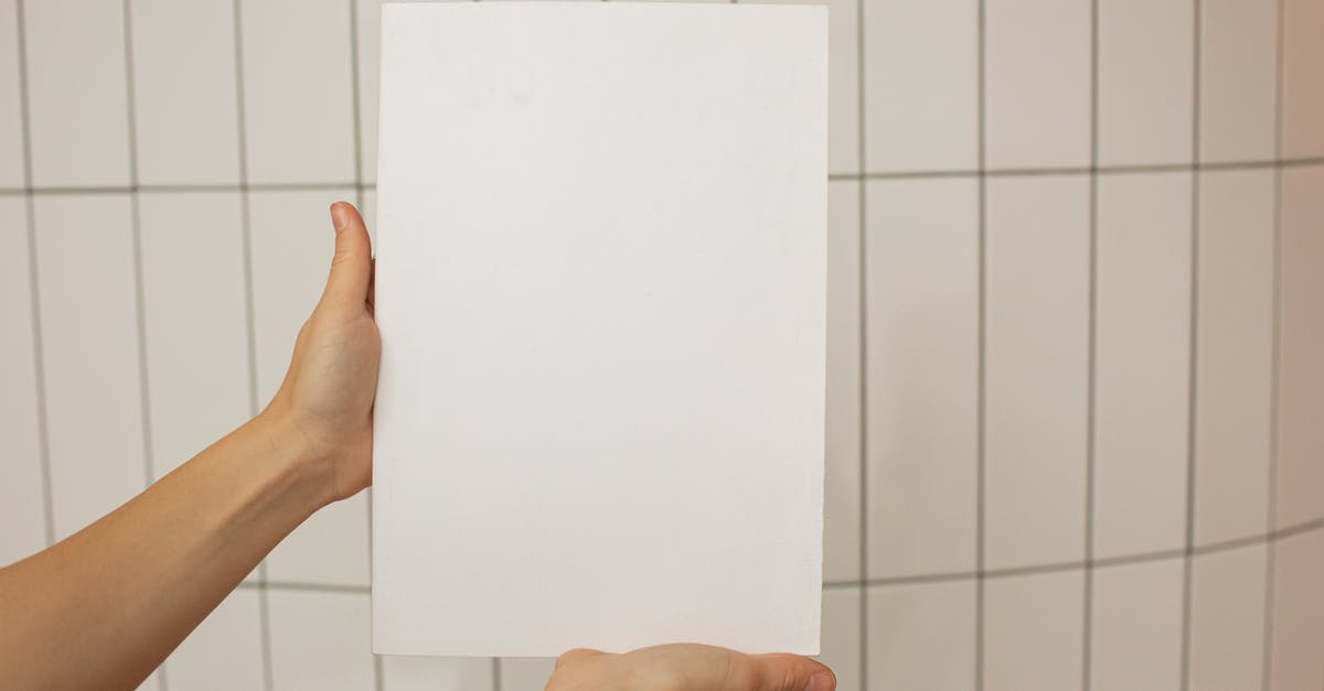 Filter to only show specific object wiring - Crop faceless person showing empty sheet of paper with tiled wall on background