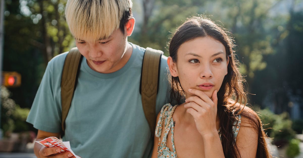 Finding the End city - Confused multiracial couple searching way in map while discovering city together during summer holidays