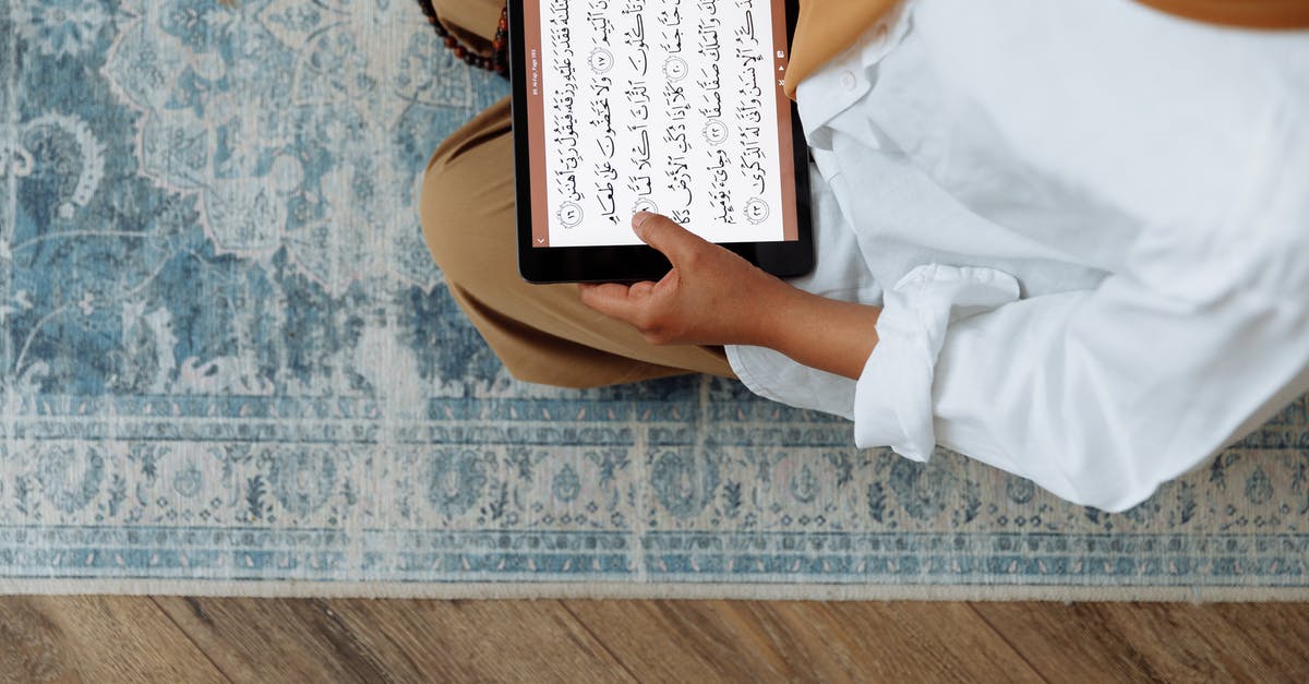 FTL - How to ALT+TAB in fullscreen? - High Angle Shot of Woman in Brown Hijab reading Quran on a Tablet 