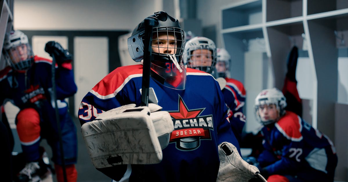 Get all players that aren't on two teams? - A Boy in Hockey Uniform Standing in the Locker Room