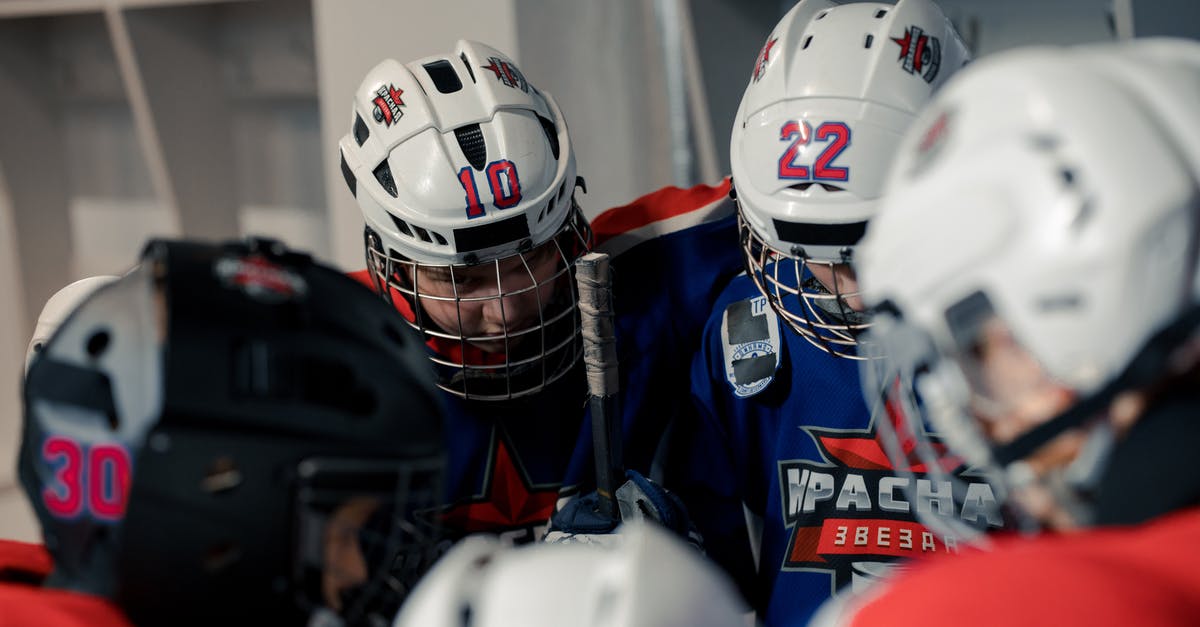 Get all players that aren't on two teams? - Hockey Players Wearing Helmet in the Locker Room