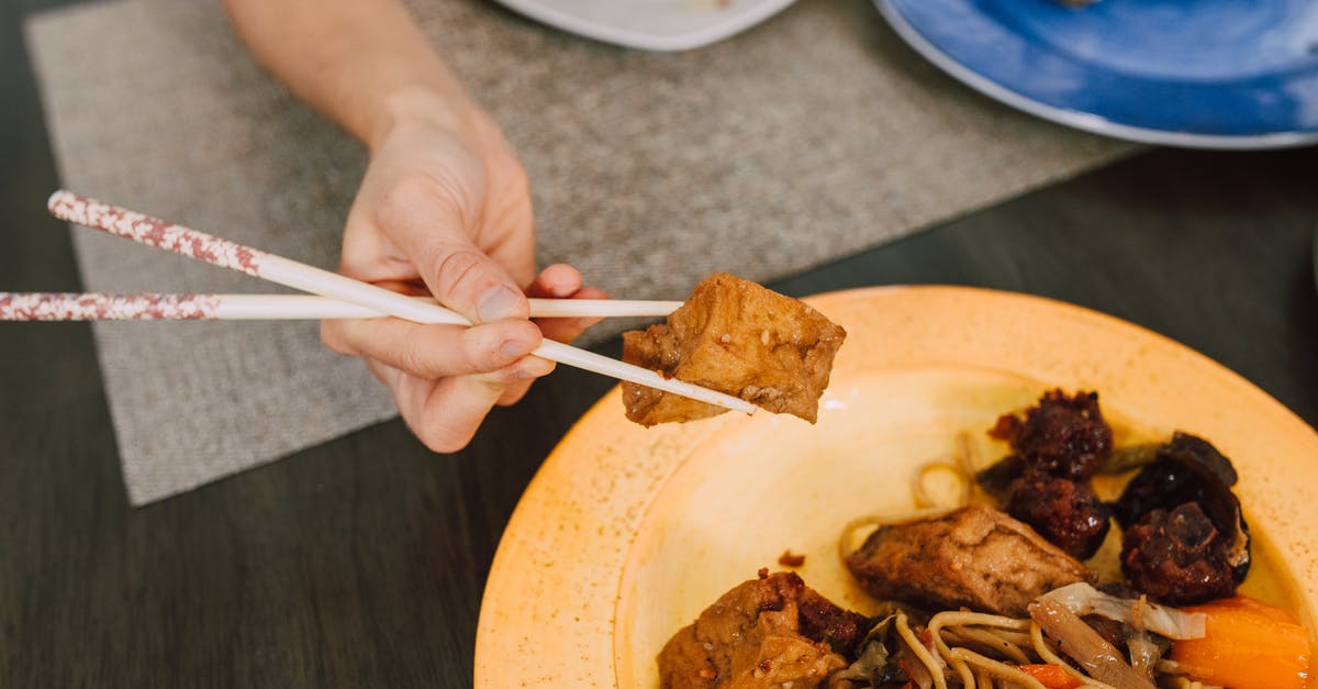 Getting multiple EXP. Shares - A Hand Getting Tofu on the Plate Using Chopsticks