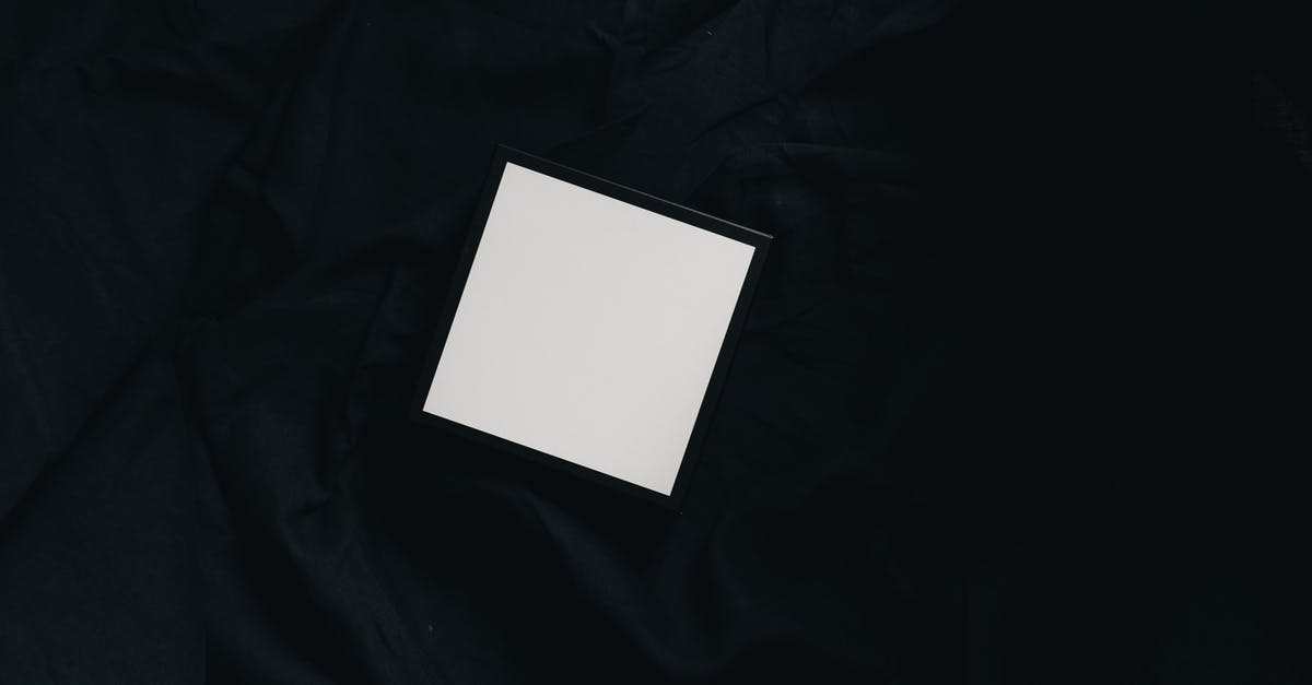 Global Operations goes to small black box after Intro Windows 10 - Top view of small white square carton present box with smooth surface and dense texture on black background