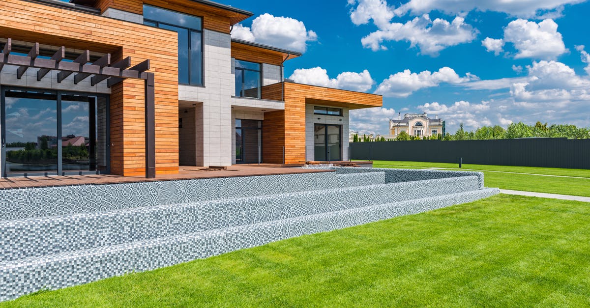 Hamachi private Lan minecraft - Exterior of contemporary residential house with panoramic windows glass doors and green lawn in yard on sunny day against blue sky with white clouds