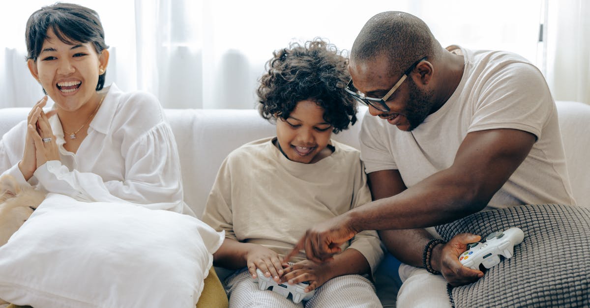 Help with the beginning of the game - Caring father teaching son using joystick