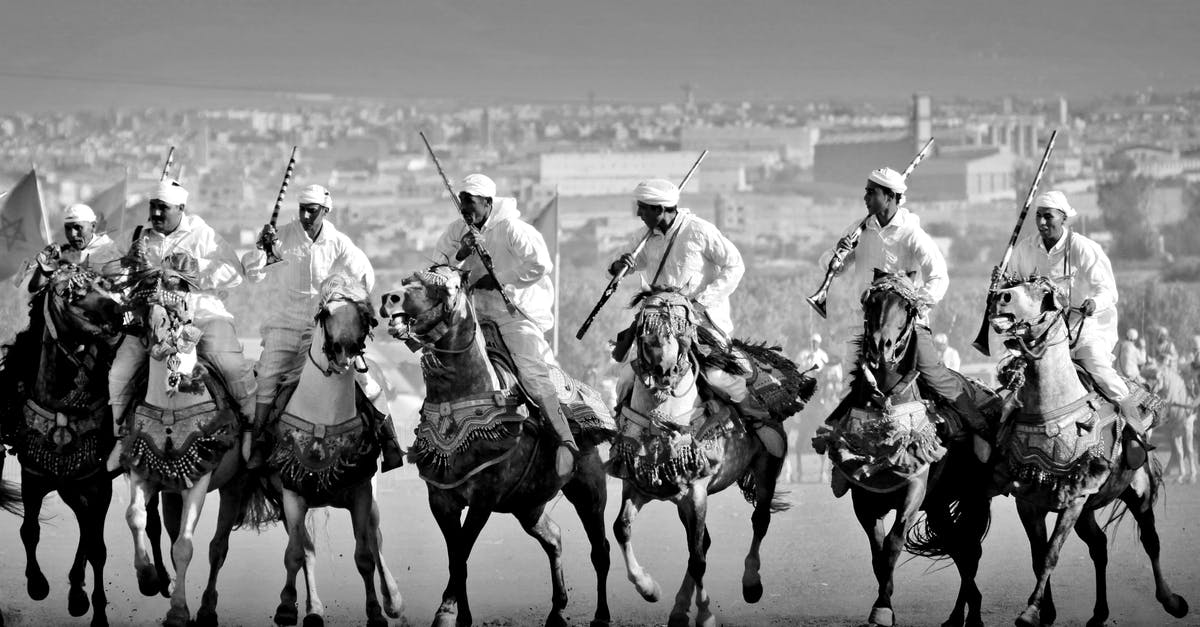 Horse Riding Combat - Grayscale Photo of Men Riding Horses Holding Weapons