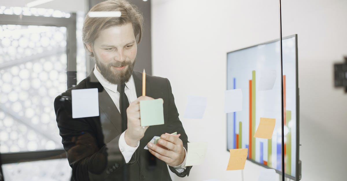 How are illusionary walls working? - Man Brainstorming in Front of Glass Wall