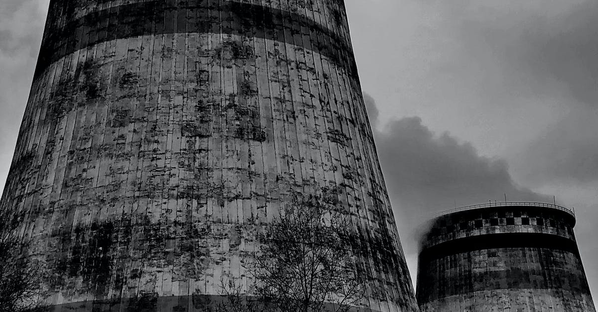 How are the recommended system specs determined on Steam? - Old draft wet cooling towers in city industrial district on cloudy sky