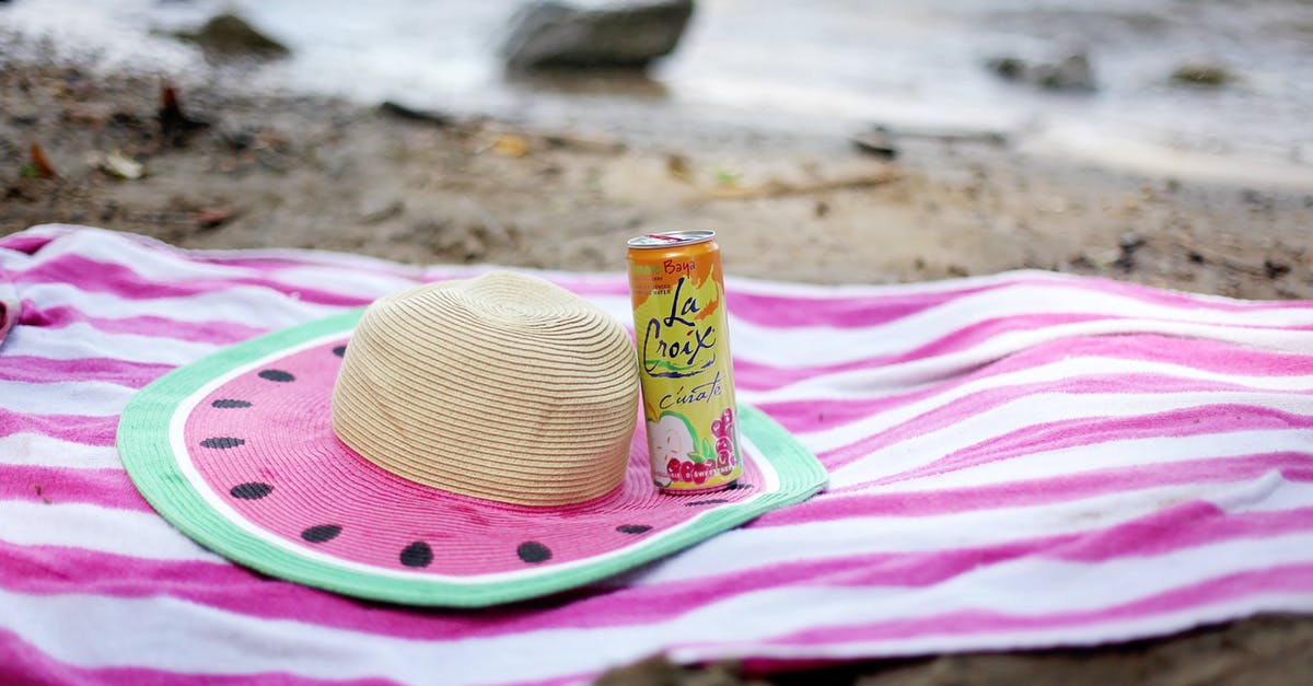 How can I afford level 30 "high end" gear? - Striped towel spread on sandy beach with straw hat and juice can