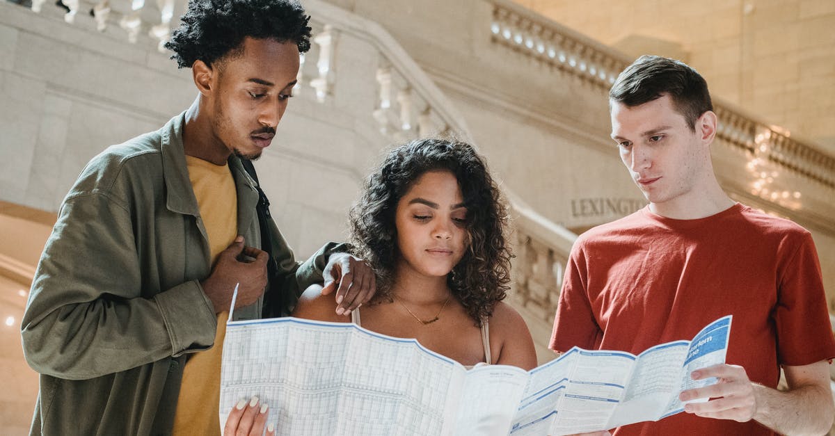 How can I check if map has some spells disabled? - Serious young diverse millennials reading map in railway station terminal