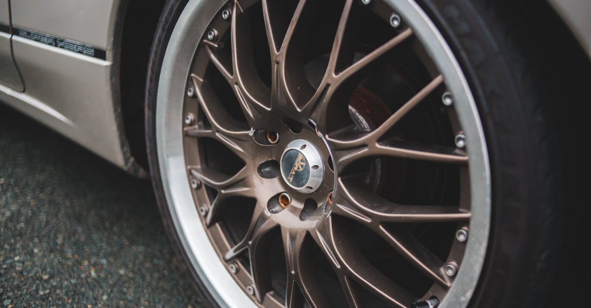 How can I clean up disk space on PS4? - Closeup of chrome wheel disk of stylish retro automobile parked on asphalt concrete road