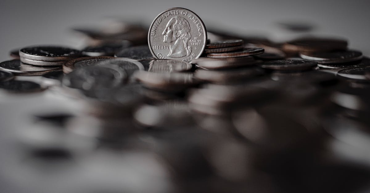 How can I convert my Tarkov USD into EUR efficiently? - Silver Round Coins on Brown Wooden Surface