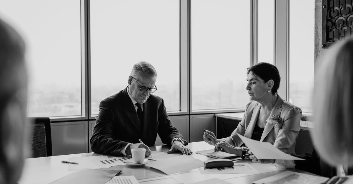 How can I effectively deal with Genji? - Grayscale Photo of Man and Woman Sitting at Table