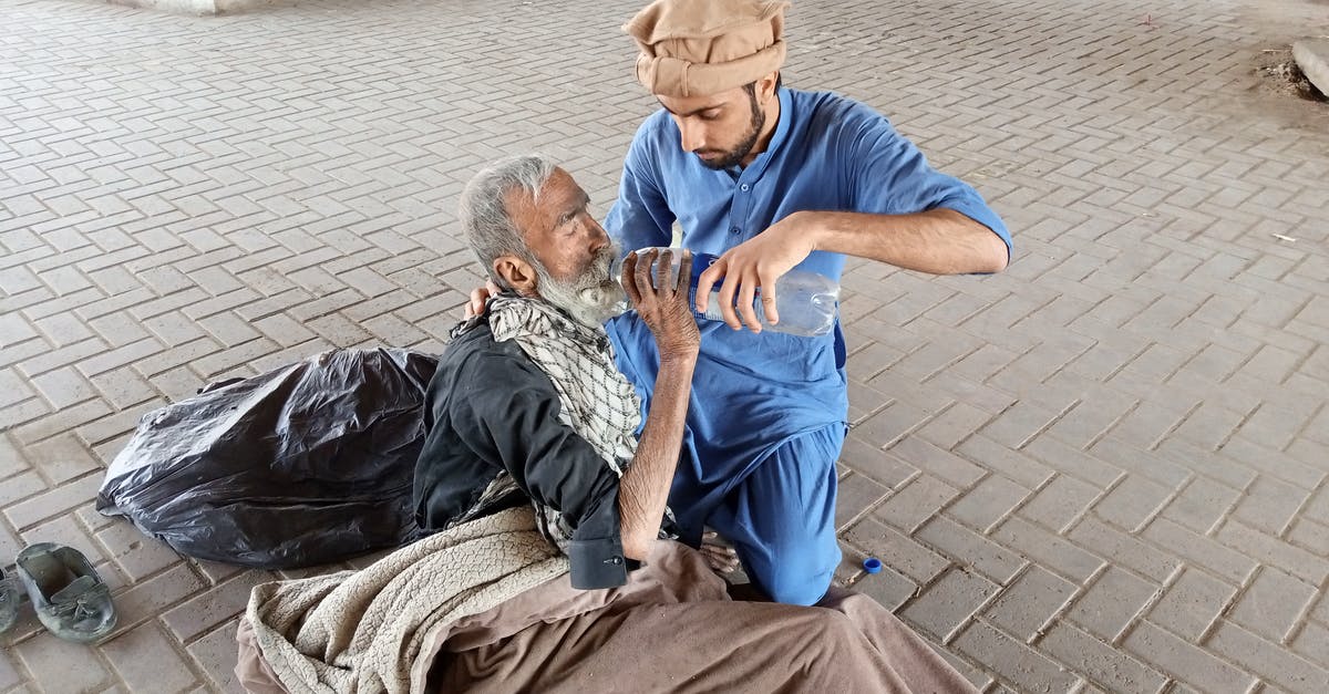 How can I help the homeless children? - Man In Blue Clothing Giving An Old Man Water