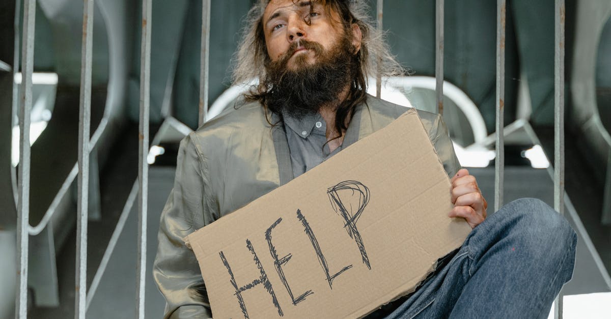 How can I help the homeless children? - A Man holding Cardboard Says Help