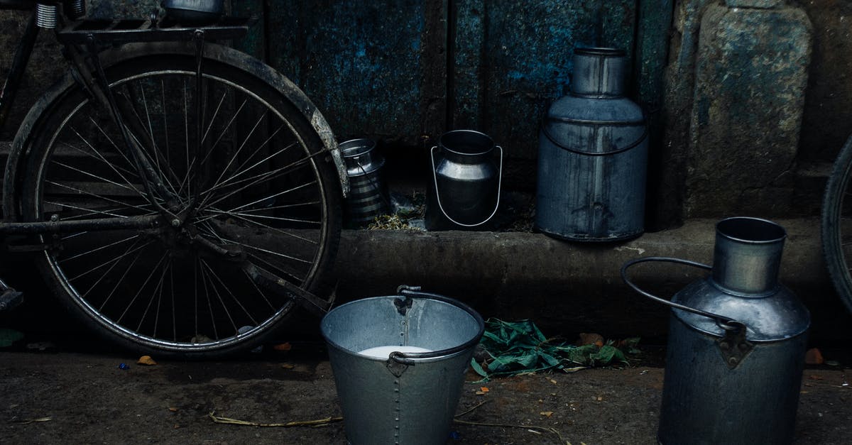 How can I remove the Damage Flash? - Tin vessels and metal bucket with milk placed near bike leaned on shabby rusty wall