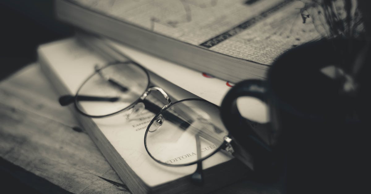 How can I separate differents enchantments from a book - Pile of textbooks near eyeglasses and mug with dried sprigs