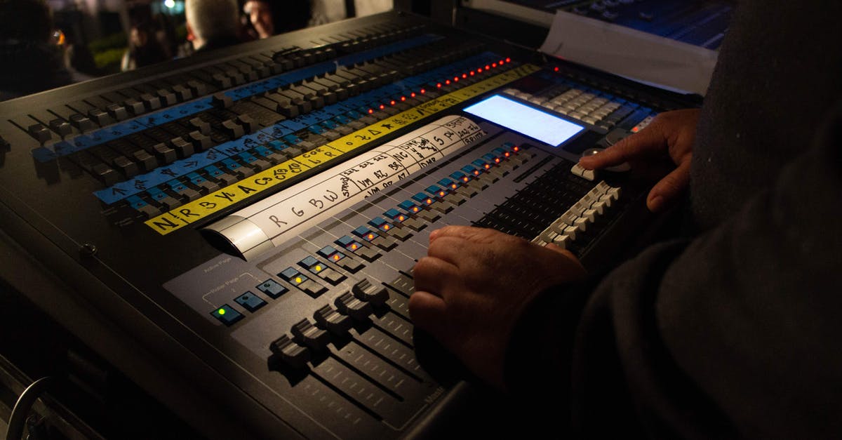 How can I show enemy health using console? - Crop anonymous male sound director adjusting faders on modern mixer board during live concert