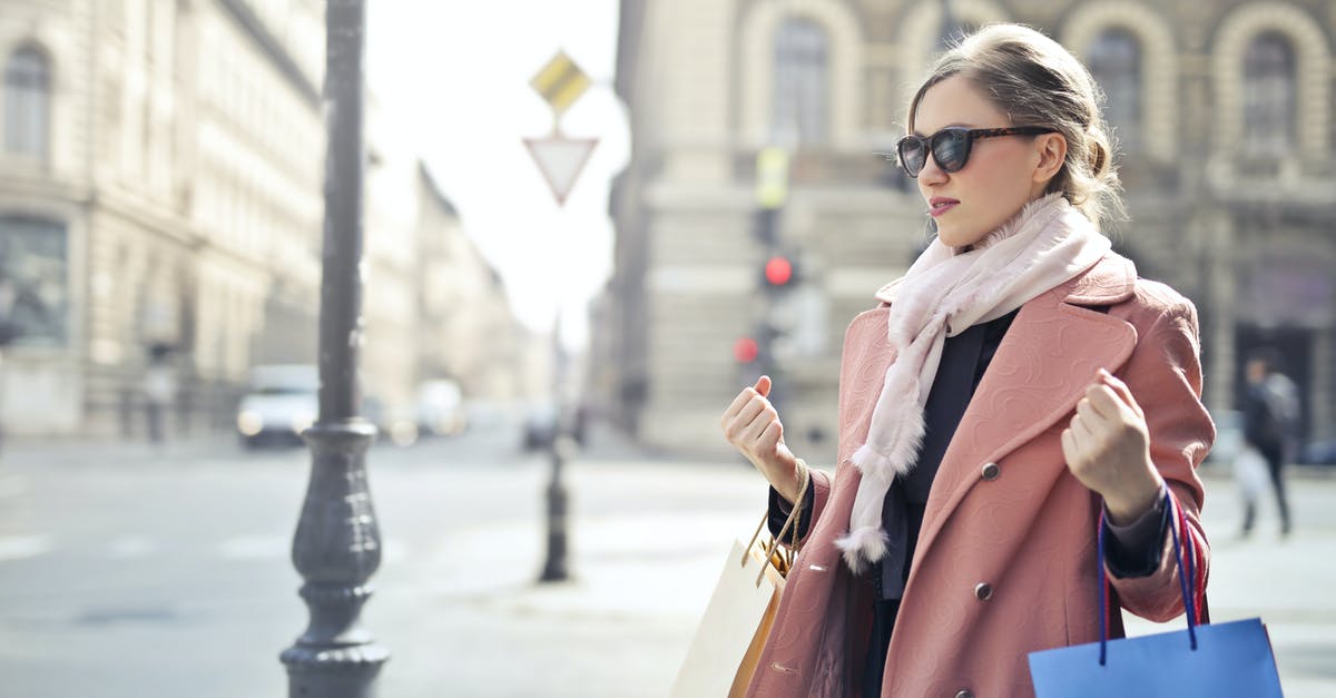 How can I sort items in my PokéBag? - Woman in Pink Coat Holding Shopping Bags