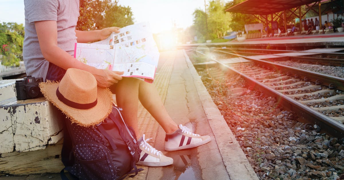 How can I track currently available maps - Man Sitting Beside Black Backpack Near Railway