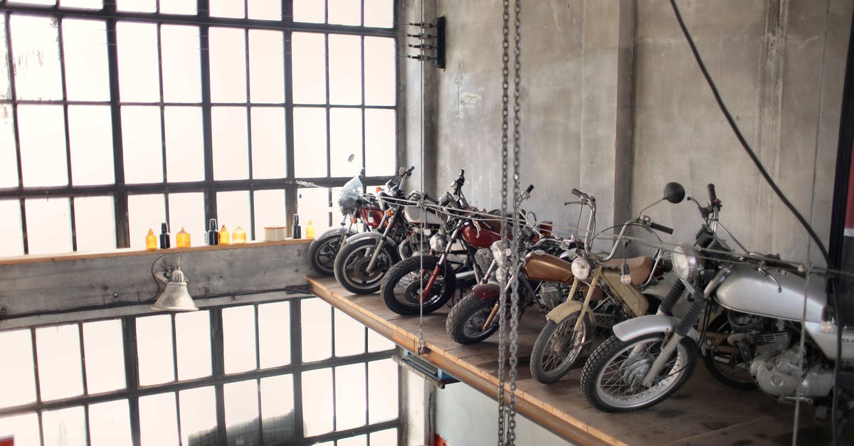 How can I use gear to optimize storage space in my stash? - Retro motorbikes parked in row on special platform in garage