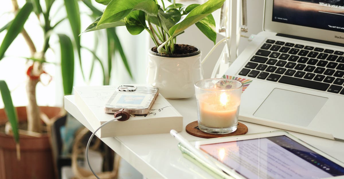 How do estus charges work? - Work Space with Candle and Charging Phone on Desk