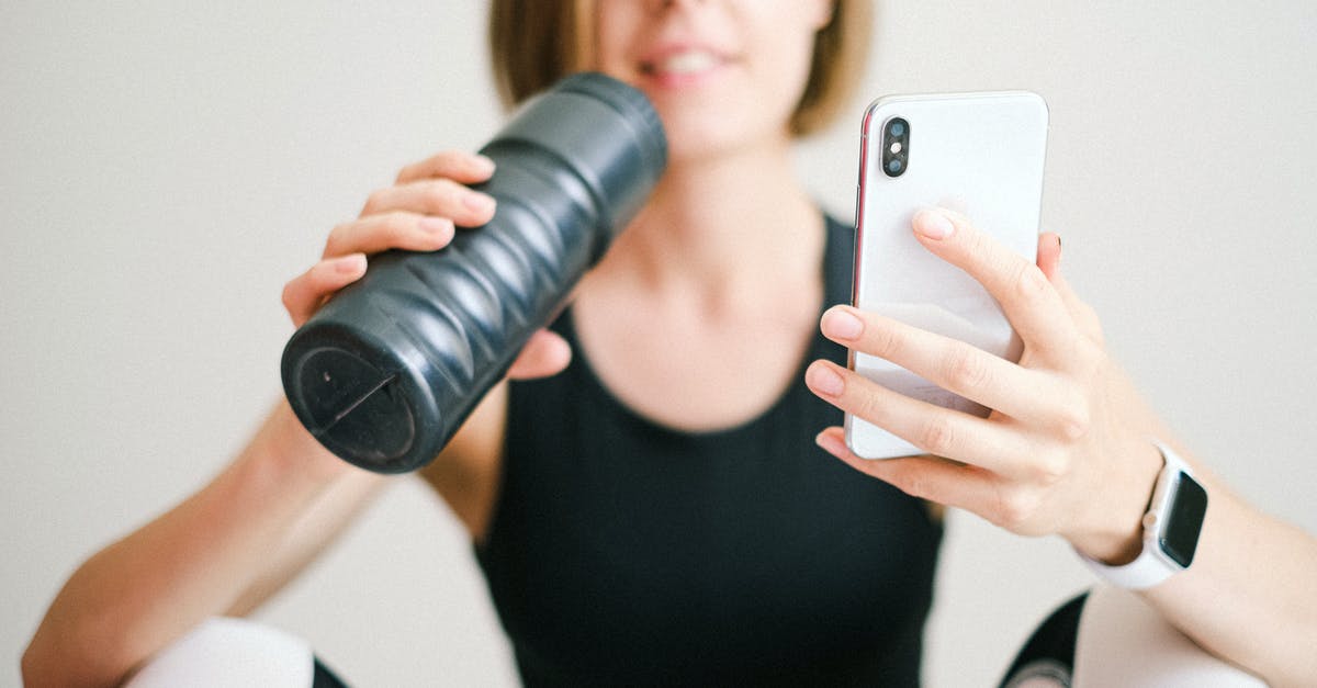 How do I activate co-op? - Photo of Woman Holding White Smartphone and Sports Bottle