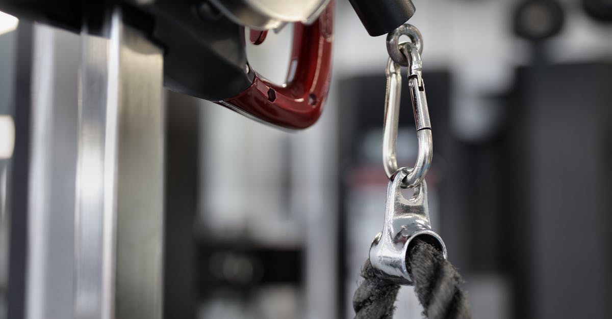 How do I attach ragdolls to other objects? - Black rope of modern exercise machine hanging on metal carabiner