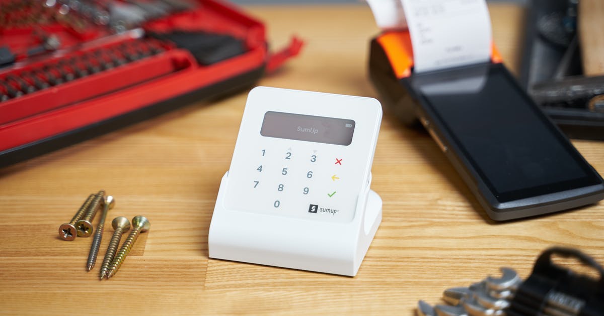 How do I build a device to pull items upwards? [duplicate] - Selective focus of white contemporary calculator surrounded by cash register and tools for repair and building on beige wooden table in bright room