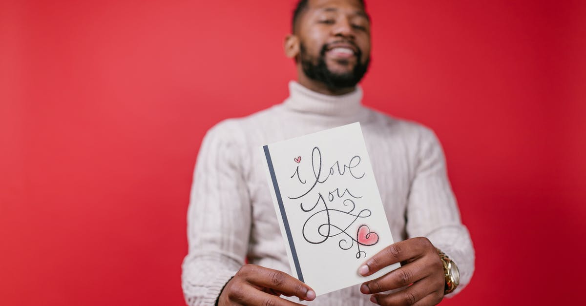 How do I calculate my blaster's damage? - Man in White Long Sleeve Shirt Holding Valentine's Day Card