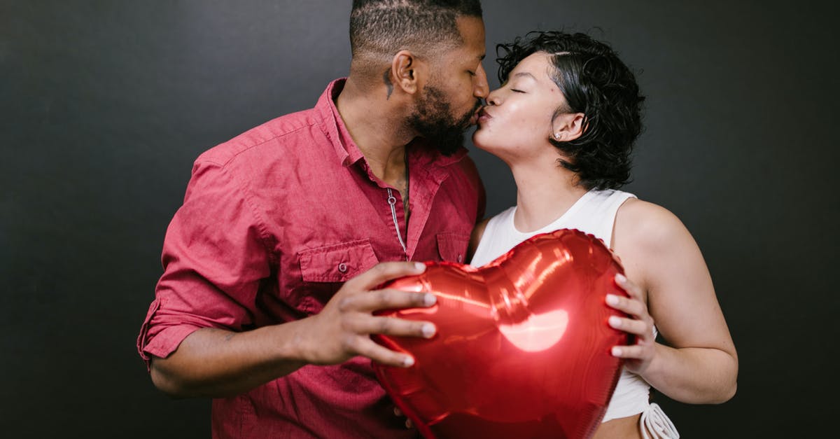 How do I calculate my blaster's damage? - Couple Kissing While Holding a Red Heart Shaped Balloon