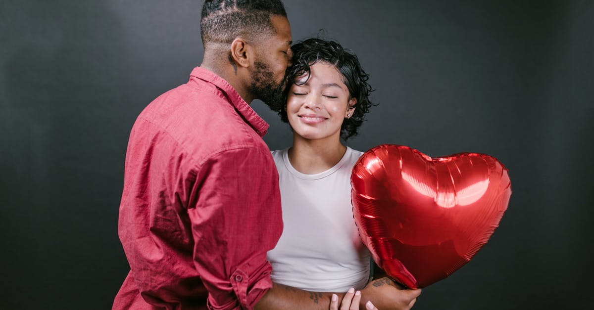 How do I calculate my blaster's damage? - Man Kissing His Woman While Holding a Red Heart Shaped Balloon