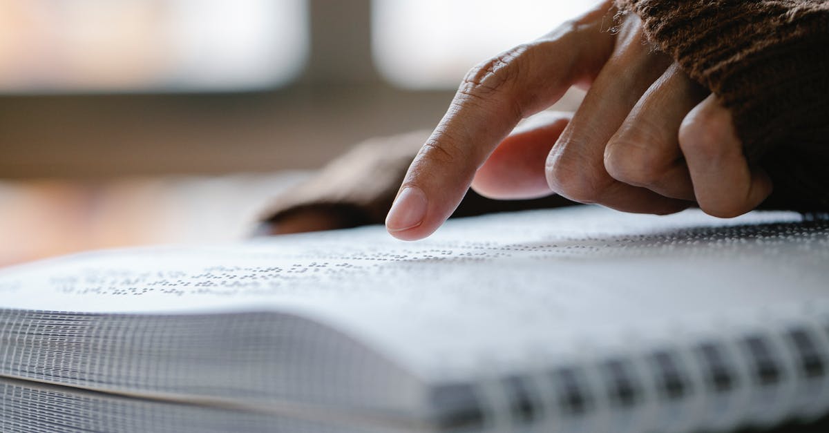 How do I change characters on The Binding of Isaac? - Photo of Person Pointing on Braille