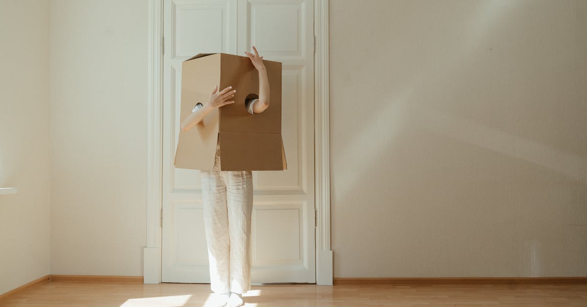 How do I change costumes? - Woman in White Long Sleeve Shirt and White Pants Standing on Brown Wooden Floor