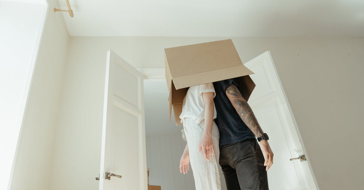 How do I change costumes? - Person in Blue Denim Jeans Standing Near White Wooden Door