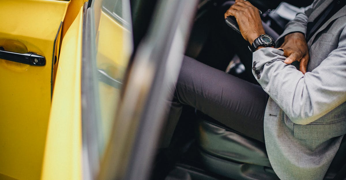 How do I check the time remaining in a song without enabling Advanced HUD? - Side view of crop anonymous African American male in elegant suit checking wristwatch in car