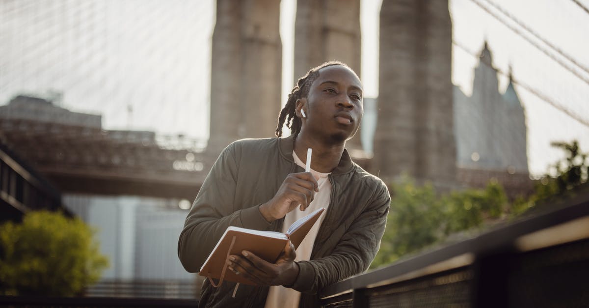 How do I check the time remaining in a song without enabling Advanced HUD? - Serious African American guy with planner waiting for meting with planner in downtown