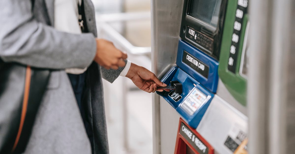 How do I connect the terminal to the turret - Side view of crop unrecognizable female in stylish clothes using credit card while buying metro ticket via electronic machine