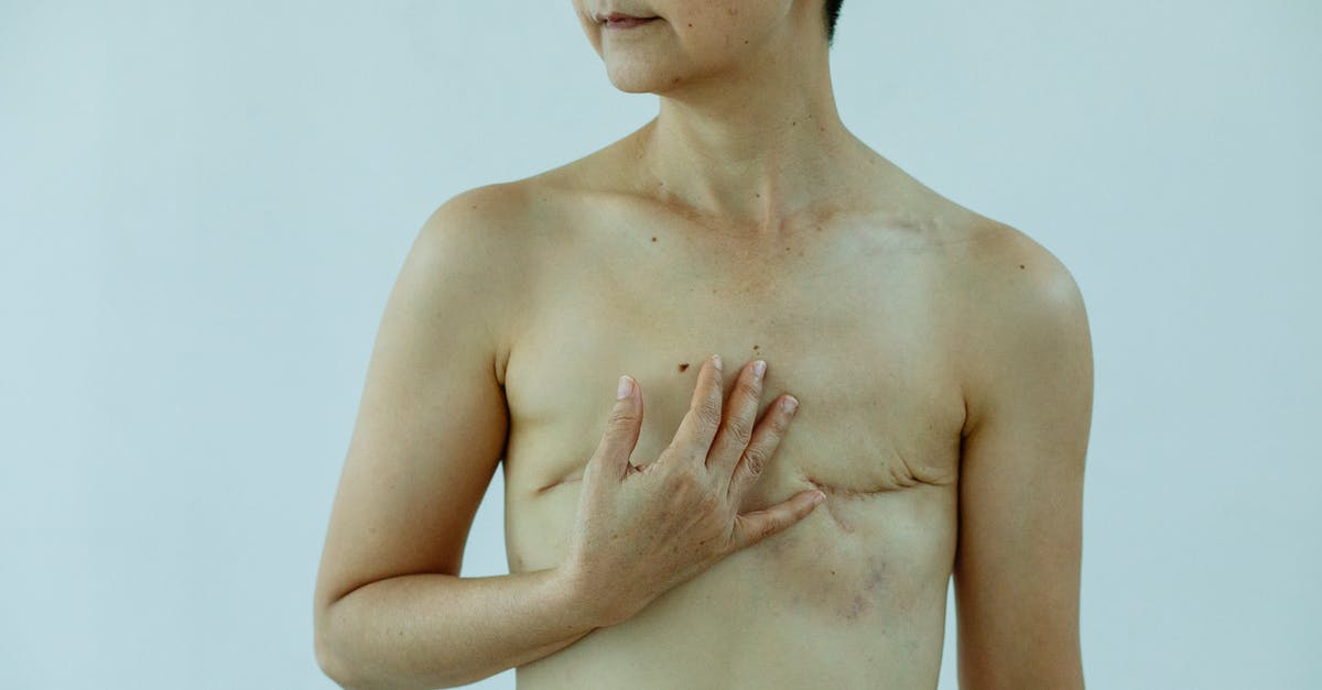 How do I defeat my own brain? - Crop anonymous female touching breast with scars after operation on white background of studio