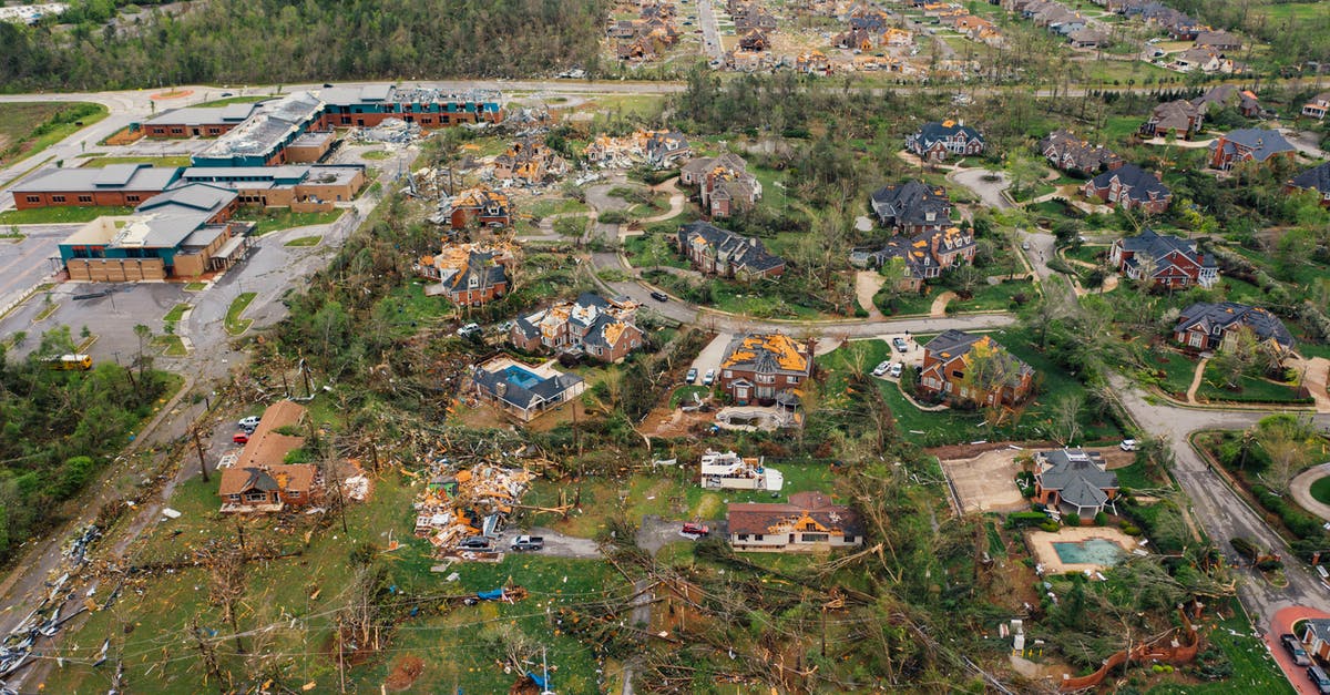 How do I dismantle a power plant? [duplicate] - Aerial view of tornado impact on small settlement cottages with destroyed roofs windthrown trees and bent electricity transmission lines