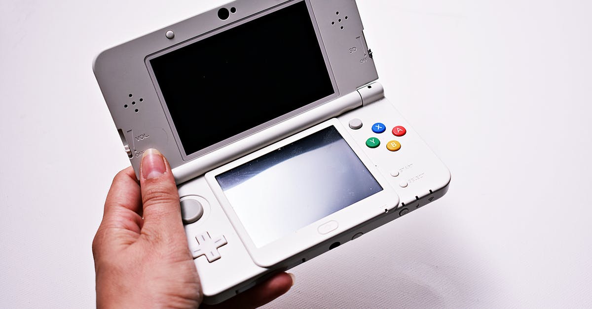 How do I effectively backup my 3DS saved games? - Person Holding Gray Nintendo Gameboy Advance