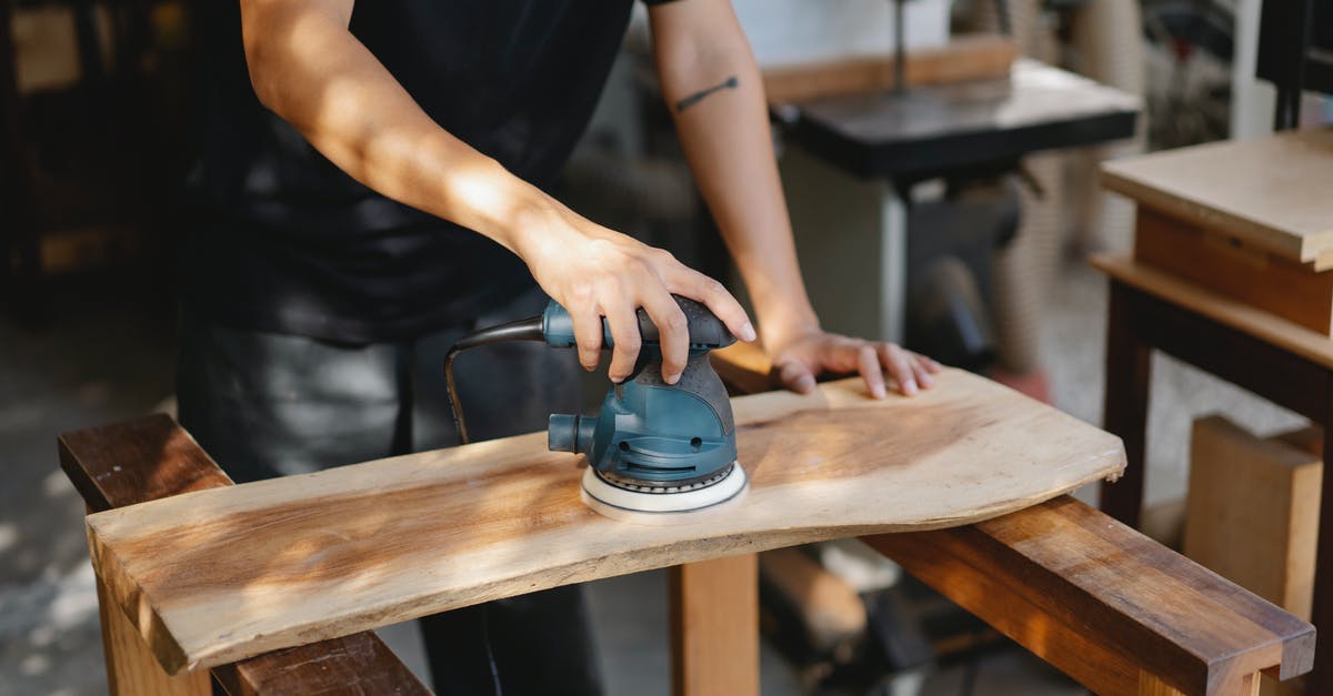 How do I efficiently grind skills? - Craftsman polishing wooden board with grinding instrument