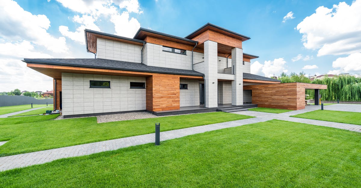 How do I enable Silent Mode? - Exterior of residential house with green trees and lawn growing in countryside in summertime