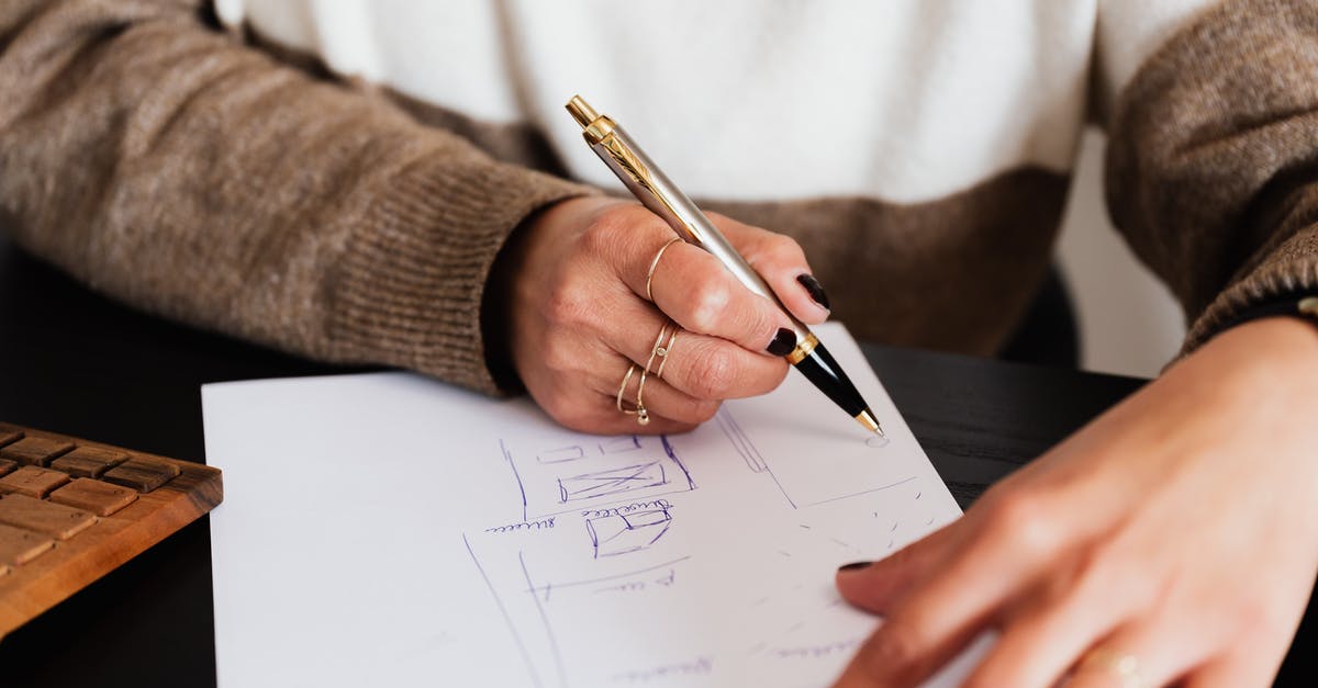 How do I estimate enemy strength? - Crop anonymous elegant lady drawing draft plan of room with pen sitting at computer desk