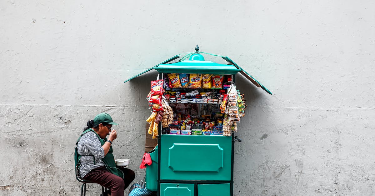 How do I get merchant chest without moving through walls? - Woman Eating While Seated Next to Mobile Shop Cart