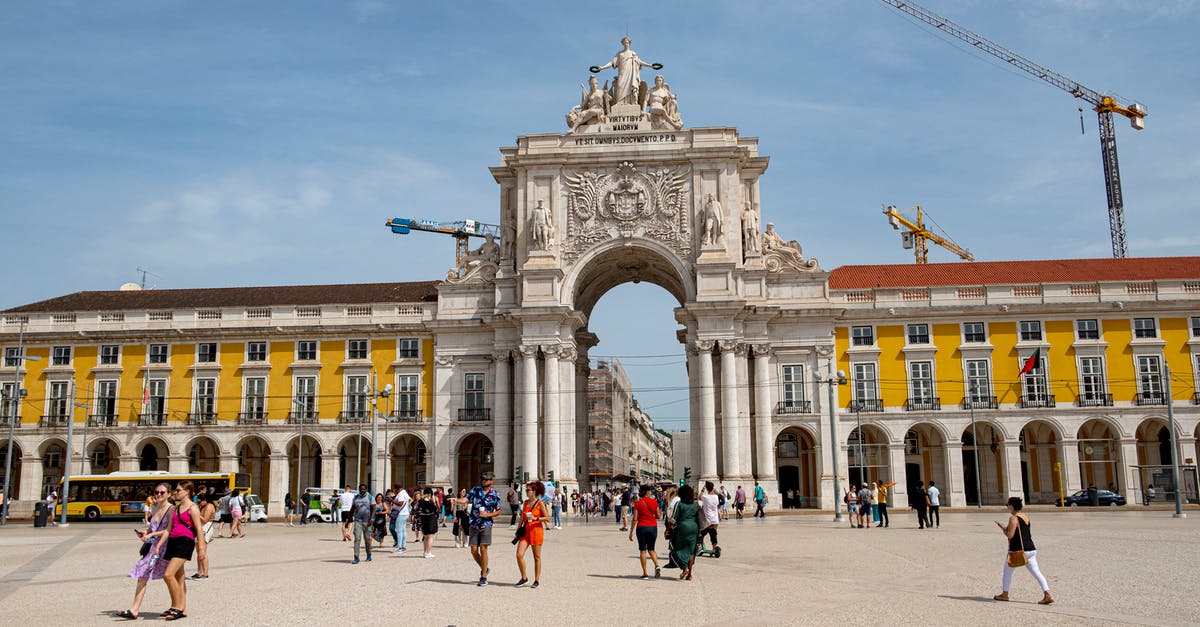 How do I get my building back? - People Walking near the Praca do Comercio Plaza