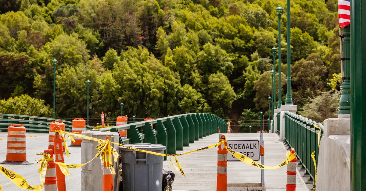 How do I get past the barriers before the vault? - Sidewalk with Bollards and caution Tape