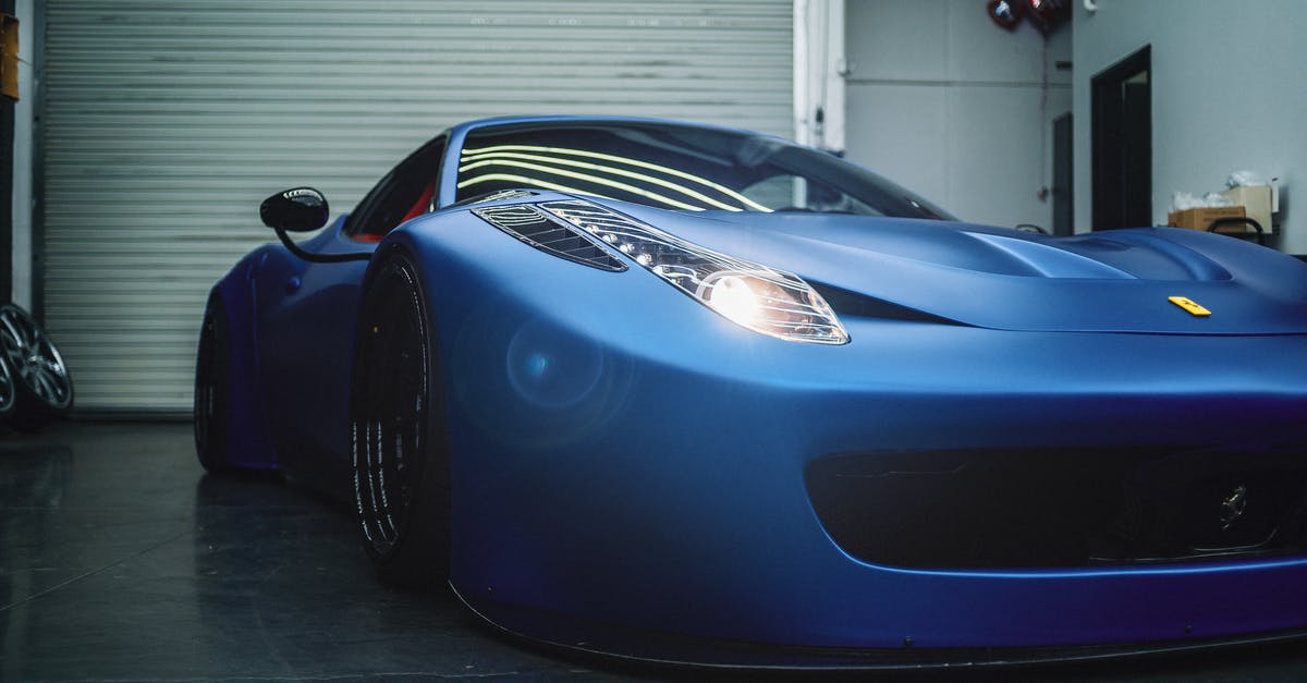 How do I get rid of low quality items? - Luxury low electric blue sports car with glowing headlights parked in grungy workshop