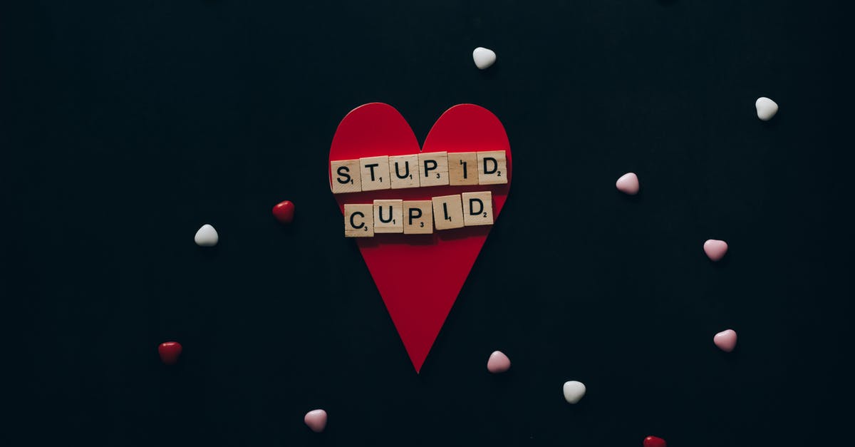 How do I keep this stupid dolphin from stealing from me? - Wooden Scrabble Tiles on Red Paper Heart